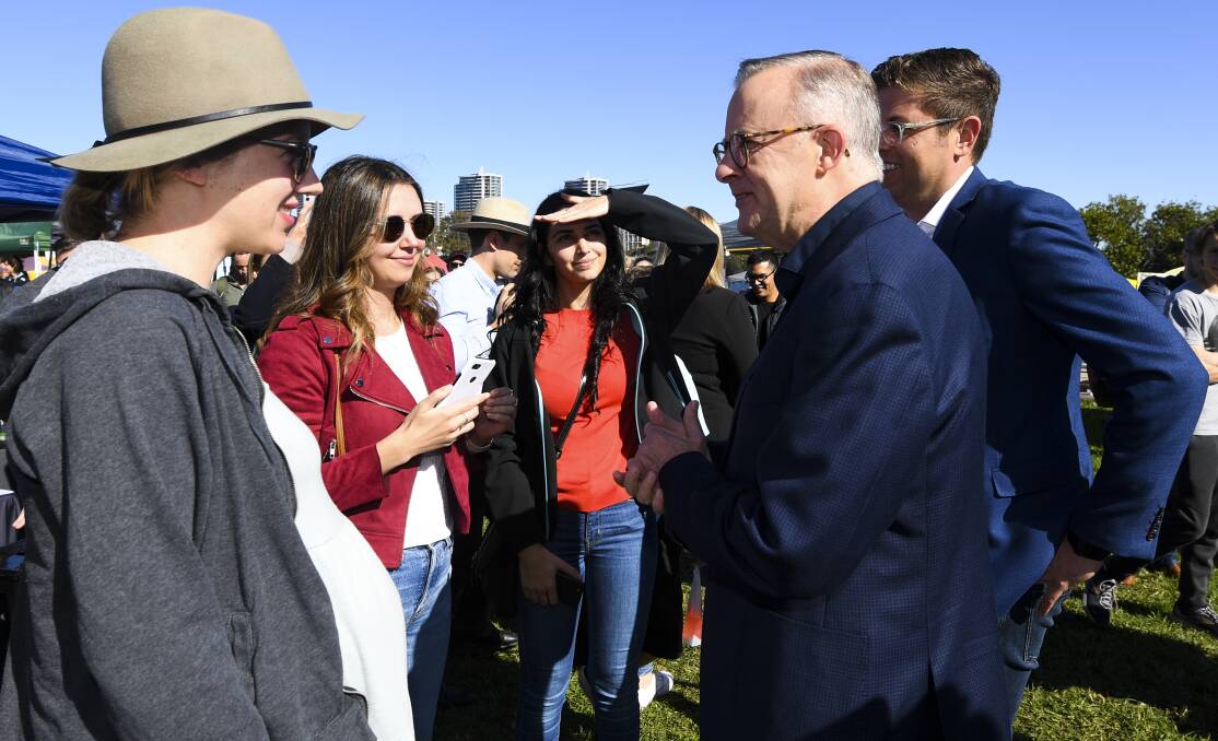 Anthony Albanese and Bennelong candidate Jerome Laxale speak with voters at the Ryde Wharf Markets in Sydney. Picture: AAP