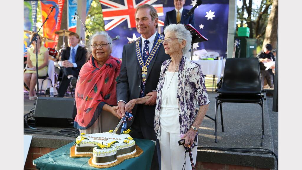 Ngambri elder Matilda House, Queanbeyan Mayor Tim Overall and 2014 Queanbeyan Citizen of the Year Beryl Carratt ready to slice up the Australia Day cake.